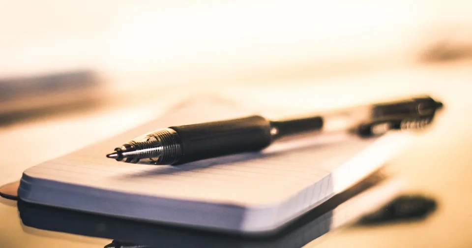 NDIS Plan Management Explained: Your Options in Plain English (2026) A pen resting on a notepad — NDIS plan management options explained in plain English